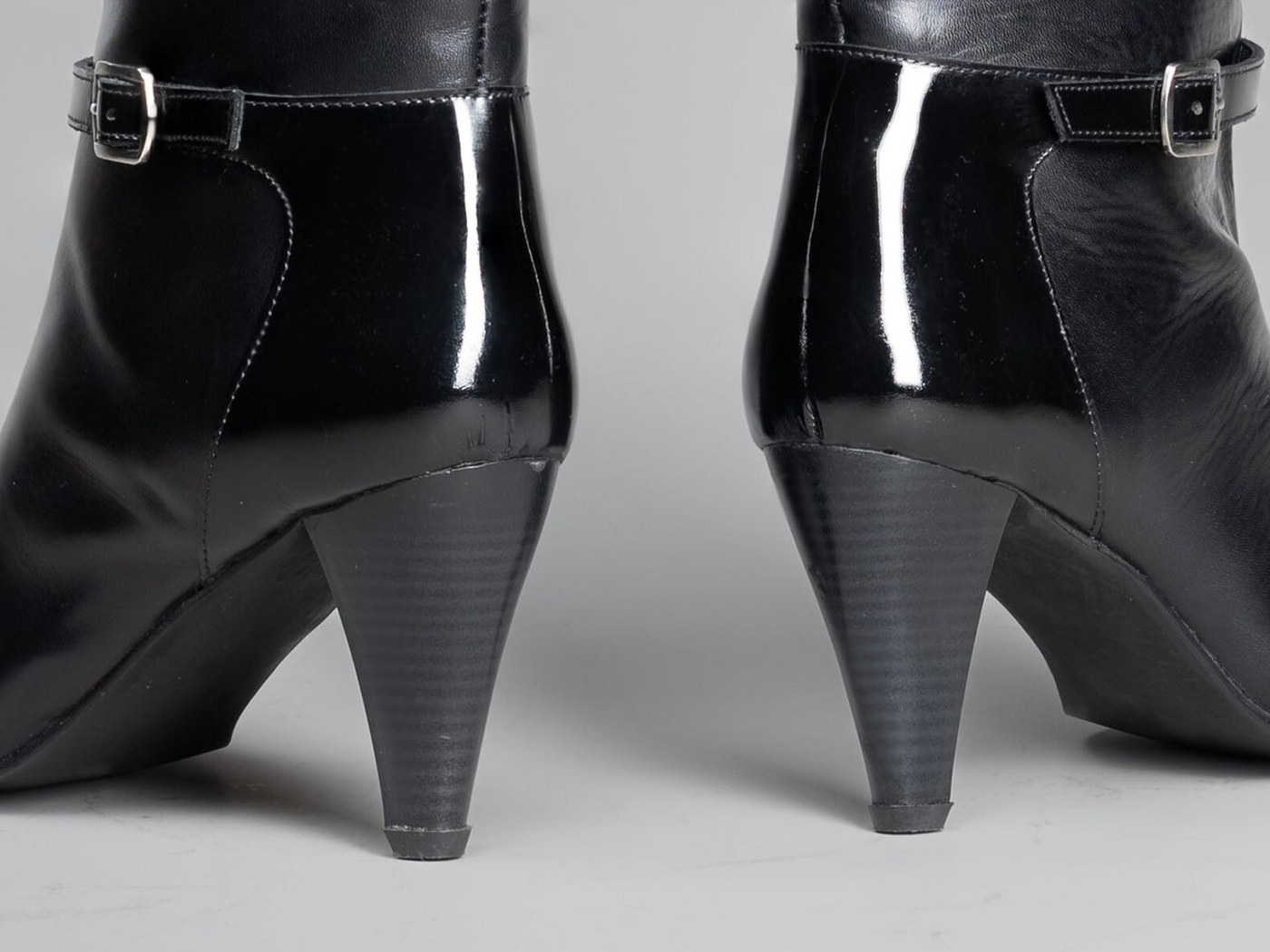 The tapered 2.5 inch pencil heel of the Cleopatra in black, seen from behind