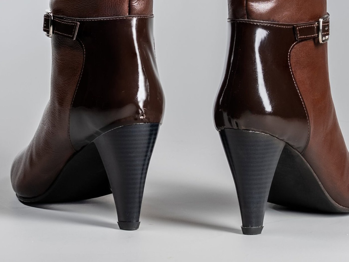 The tapered 2.5 inch pencil heel of the Cleopatra in brown, seen from behind