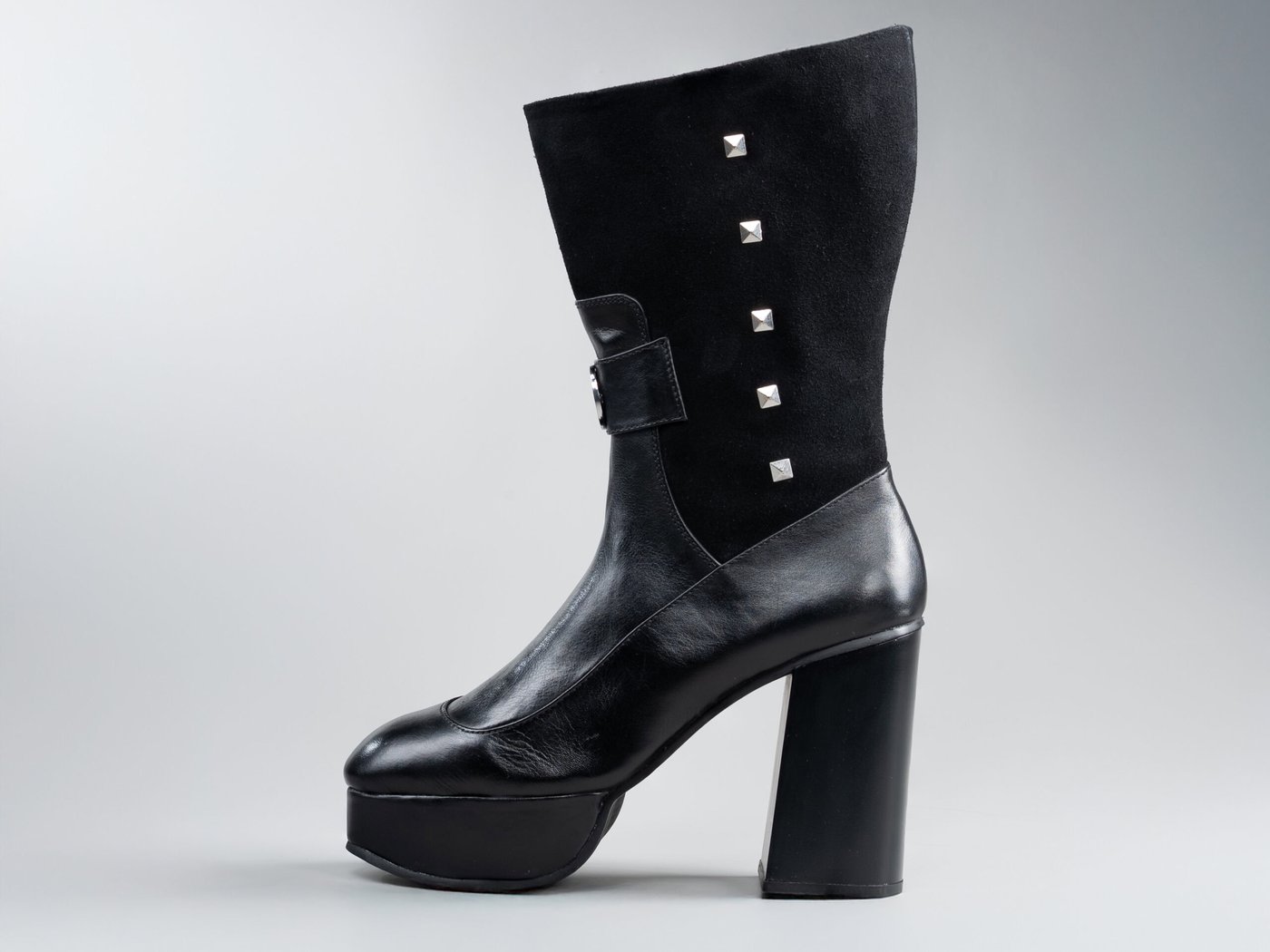 The Valentina, side profile in black full-grain leather on a 1 inch platform