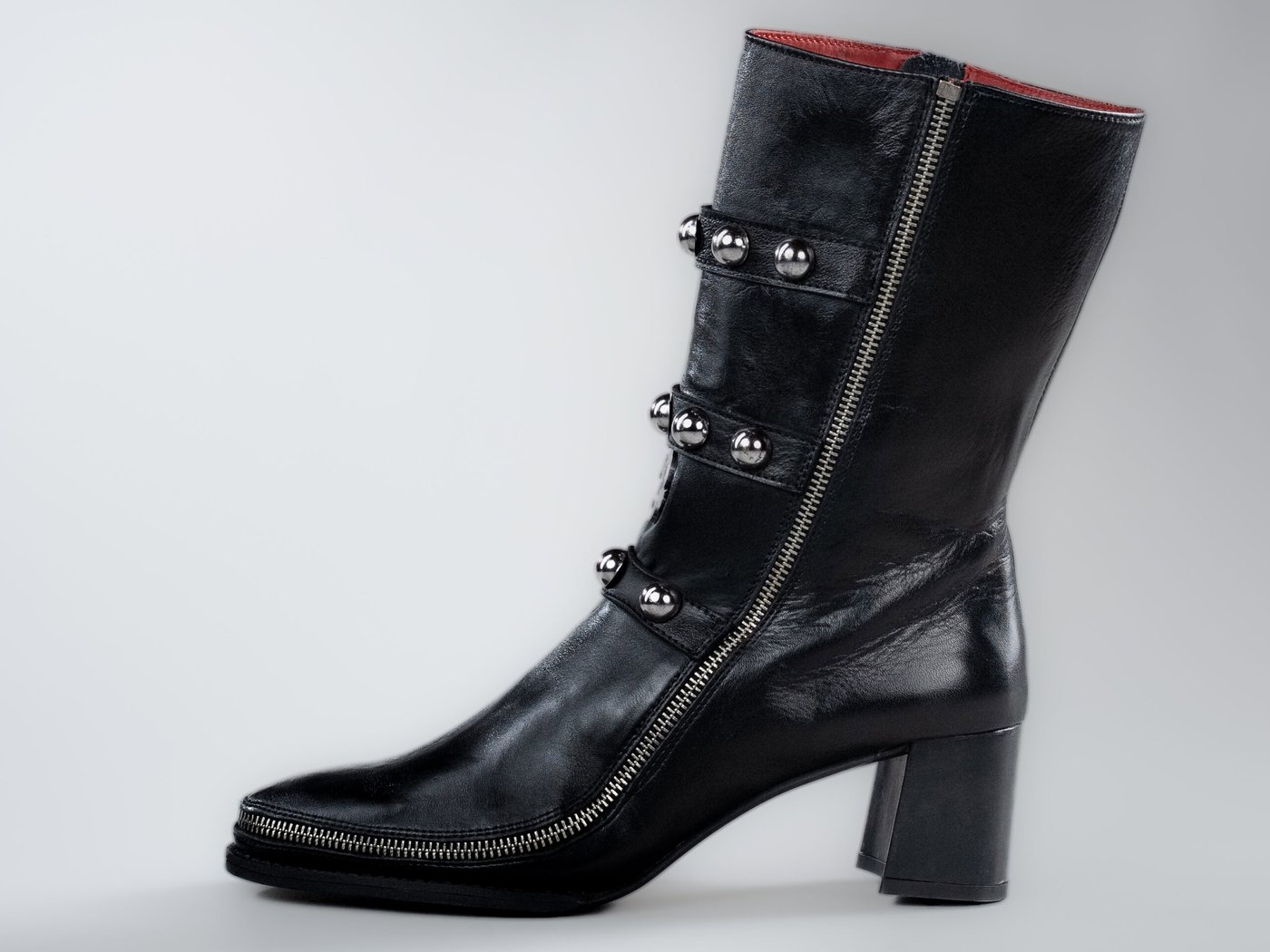 The Vivienne, side profile in black full-grain leather with three studded straps